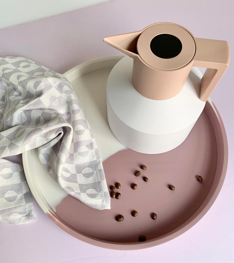 geo flask on a tray with a tea towel and coffee beans
