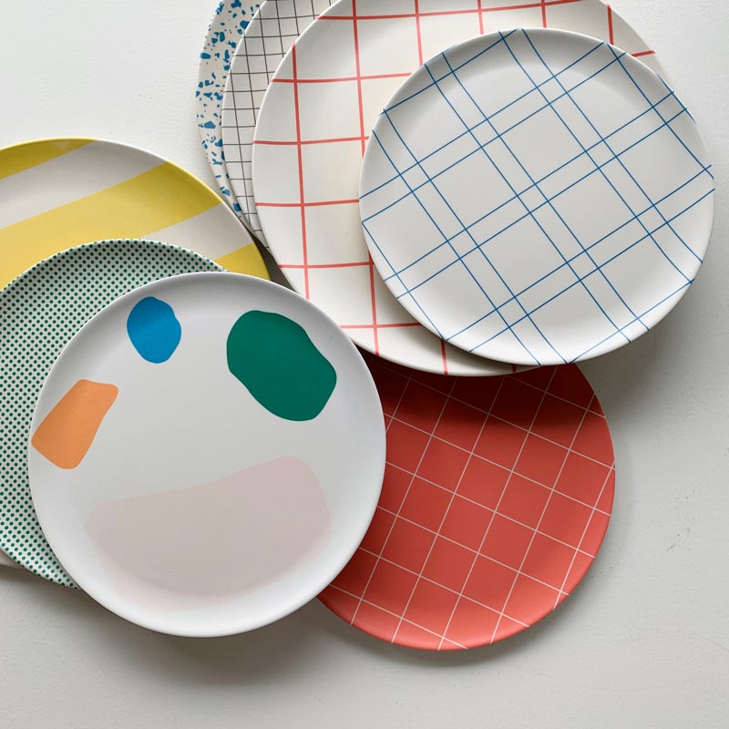a group of plates printed with patterns of grids, stripes and dots