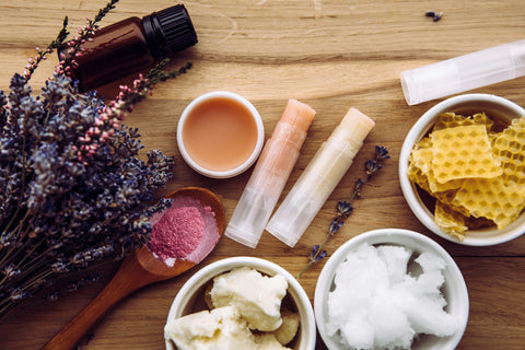 A selection of carrier oils, waxes, essential oils, and vitamin E for making lip gloss