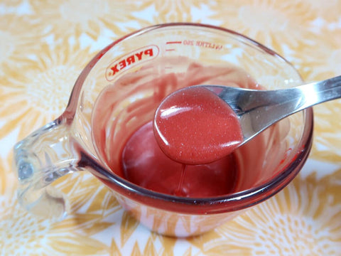 A container of homemade lip gloss