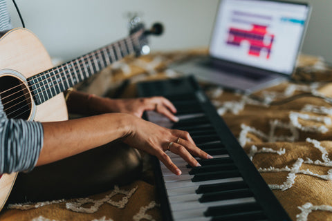 Person playing piano with guitar