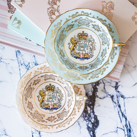 Pair of Paragon teacups in pink and blue to mark the visit by Queen Elizabeth and Prince Phillip to Canada in 1959.