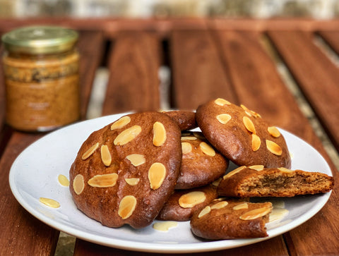 Almond butter cookies with skinnyg's almond butter in the background