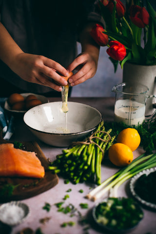 Person cooking with ingredients on a table