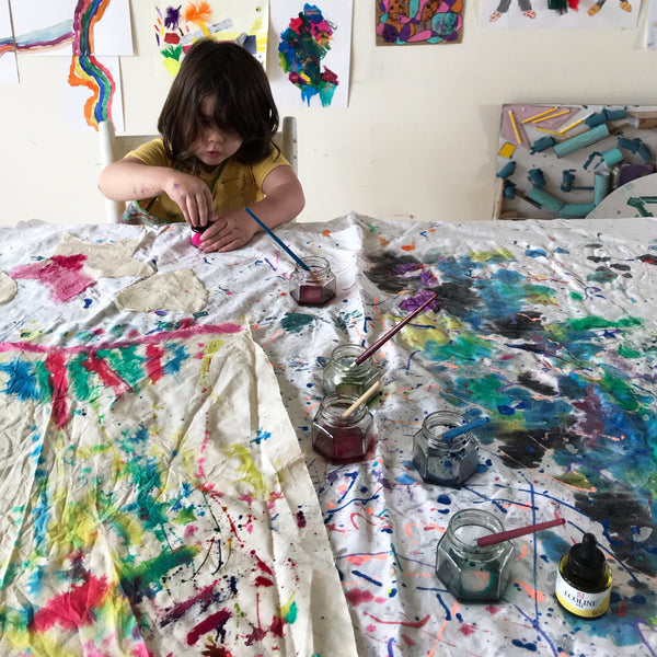 child painting fabric with ink