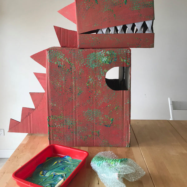 a painted cardboard box dinosaur costume