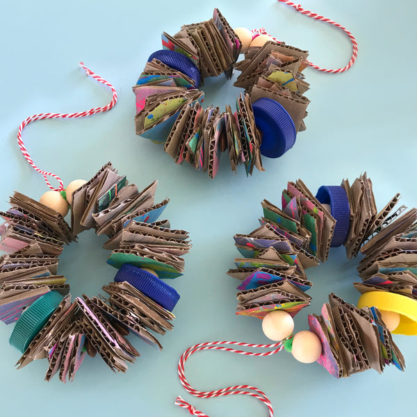 up-cycled cardboard and bottle top christmas wreaths