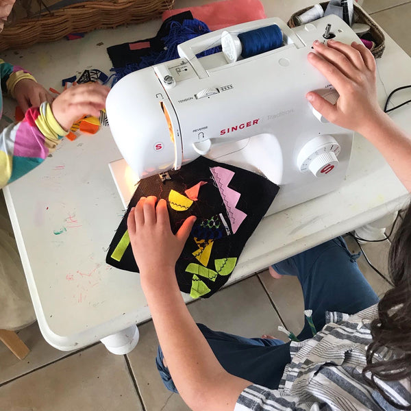 child using a sewing machine