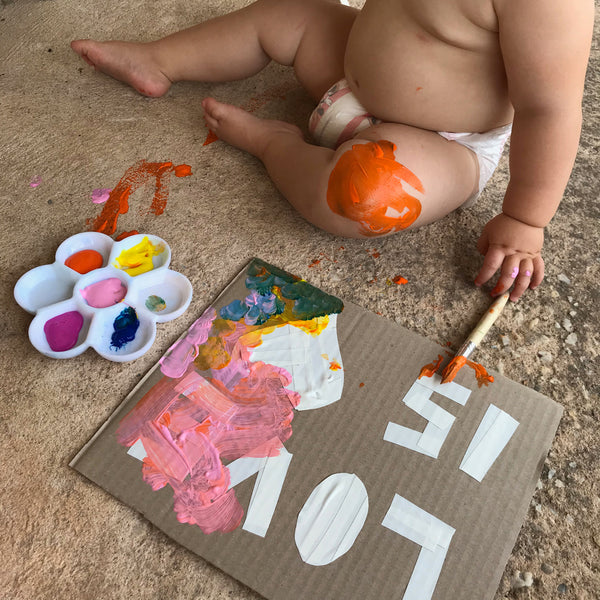 toddler doing messy painting