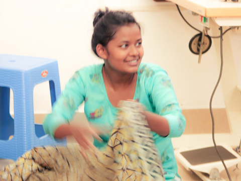 Munu inspects a sari purchased at the bazaar.