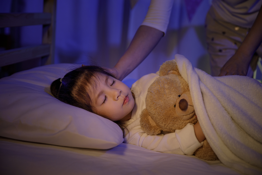 girl sleeping with teddy bear.png