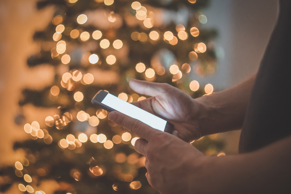 phone with christmas tree lights backdrop