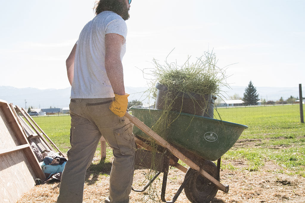 Man in Lightweight Gloves hauling hay on farm