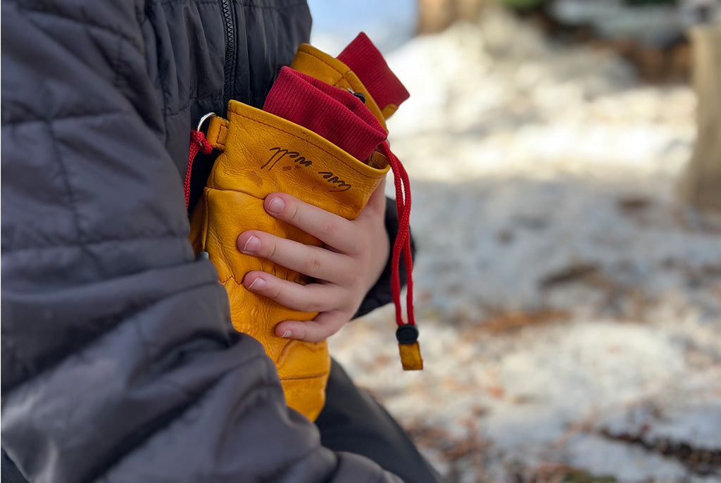 Person holding Limited Edition Live Wild, Live Well Frontier Mittens