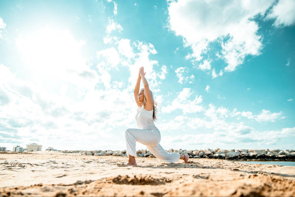 Woman doing yoga on the beach