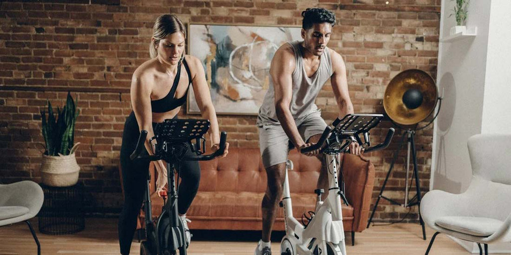 Couple exercising on bikes
