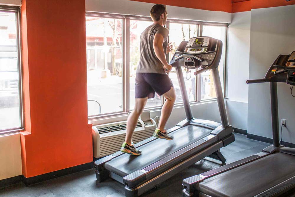 Man burning calories running on treadmill