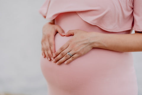 Can you get lash extensions while pregnant? Blog -- Lady holding her belly.