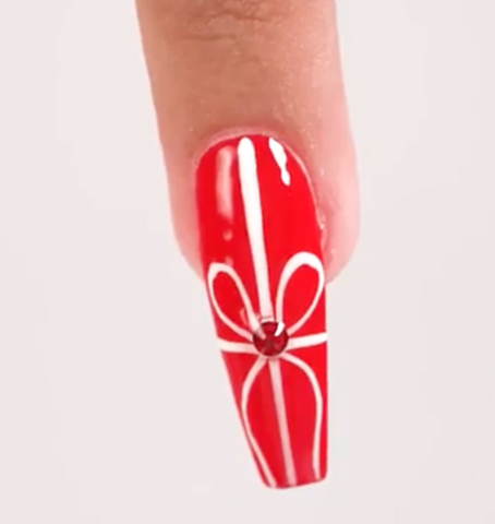 Christmas present nails using red nail polish from our Holiday Collection at PLA. 