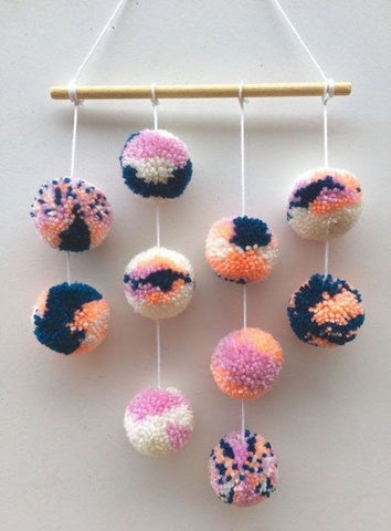 photo of wall hanging made of pom poms