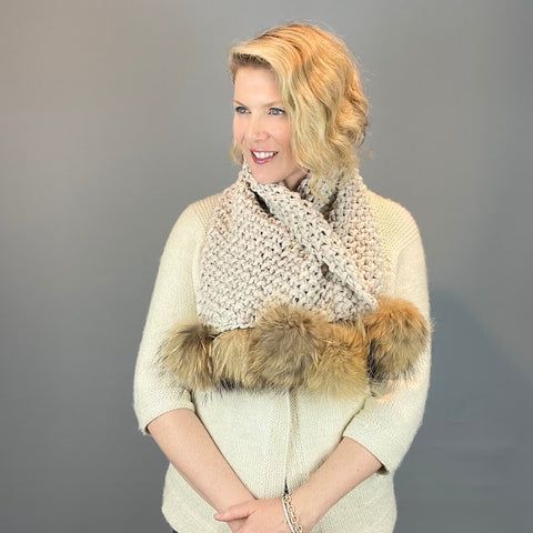 Photo of woman in pompom scarf