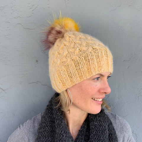 photo of person with yellow knit hat