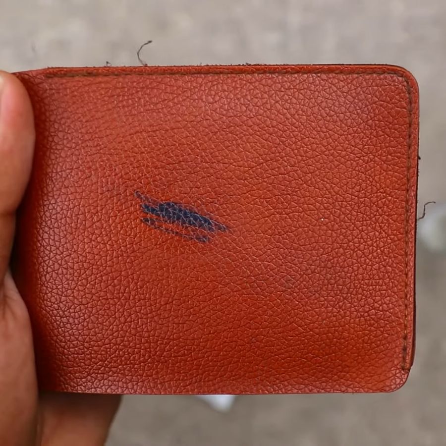 Wallet with ink and pen marks on it