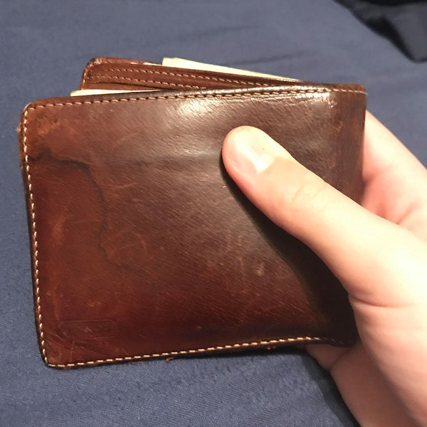 Hello! I have this weird dried out, white streak on my wallet and I'm not  too sure if it's some sort of stain or dried leather. Wasn't too sure how  to get