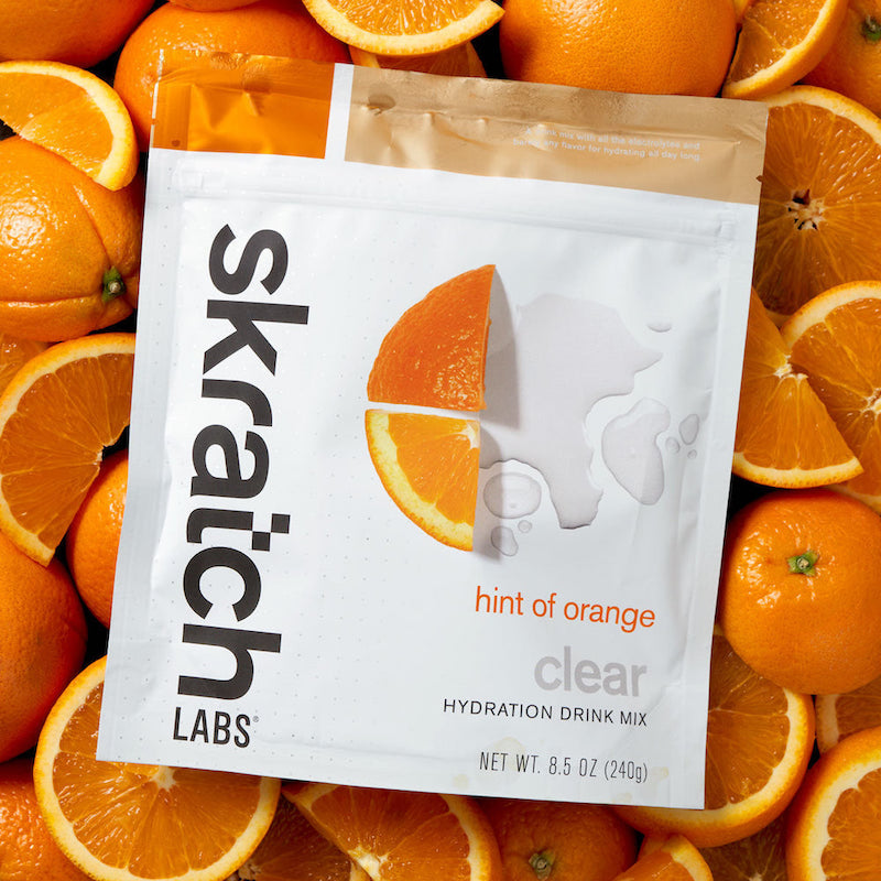 Skratch Labs Clear Hydration Drink Mix Orange Fruit Background