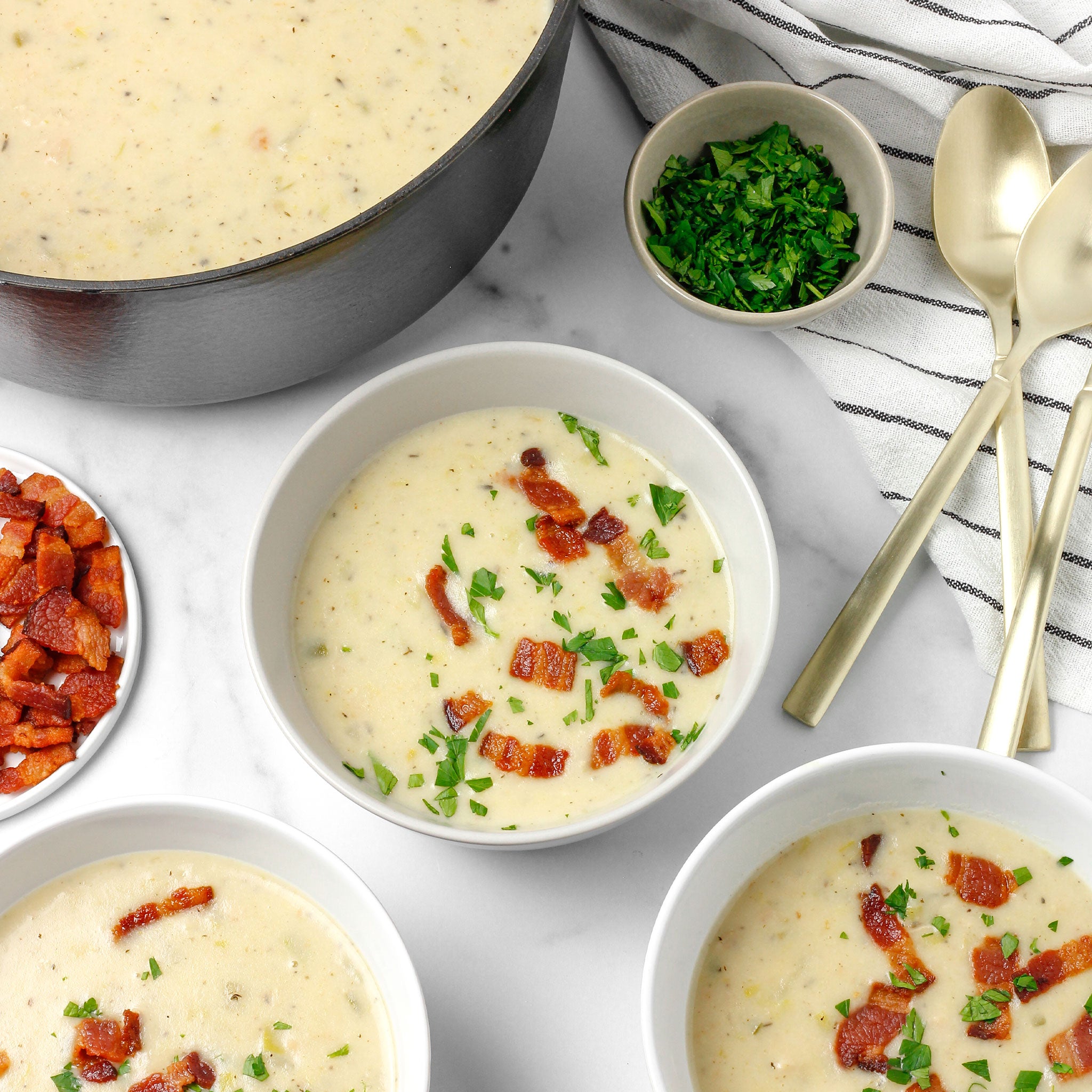 Clam chowder in white bowls