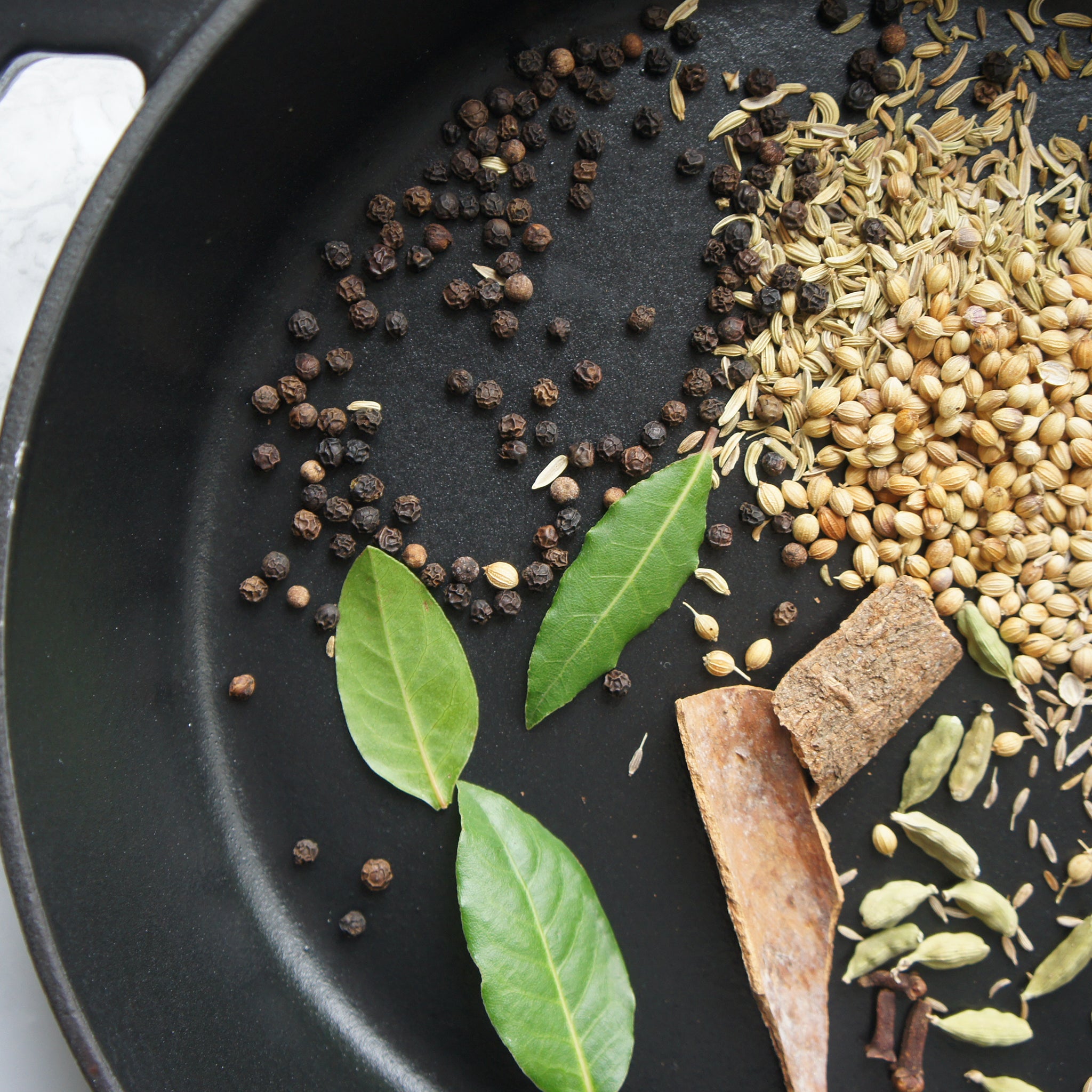 garam masala spices in cast iron skillet