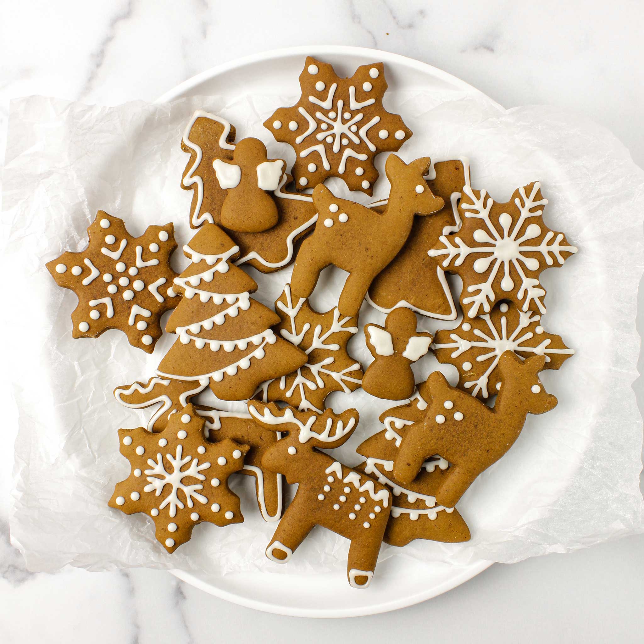 Gluten free gingerbread cookies decorated with white icing