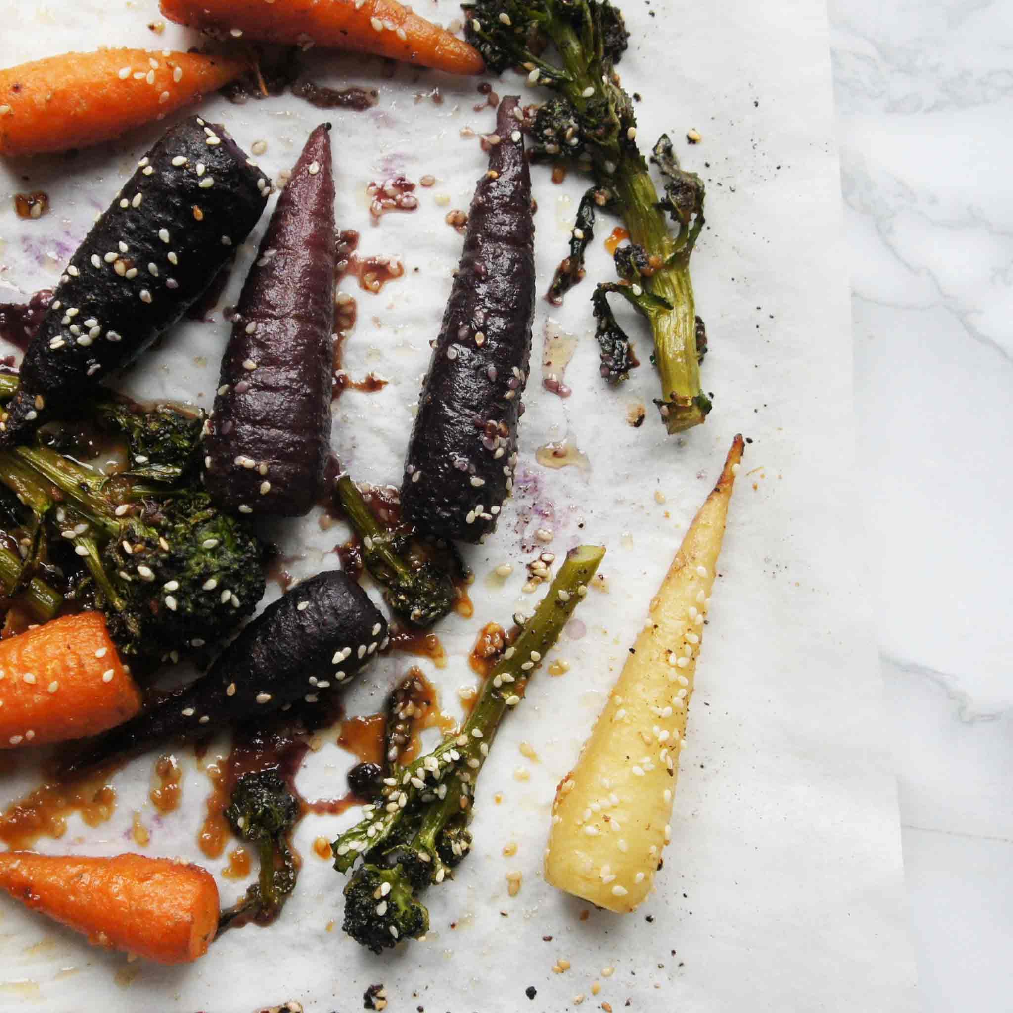 Roasted veggies on a parchment-lined baking tray