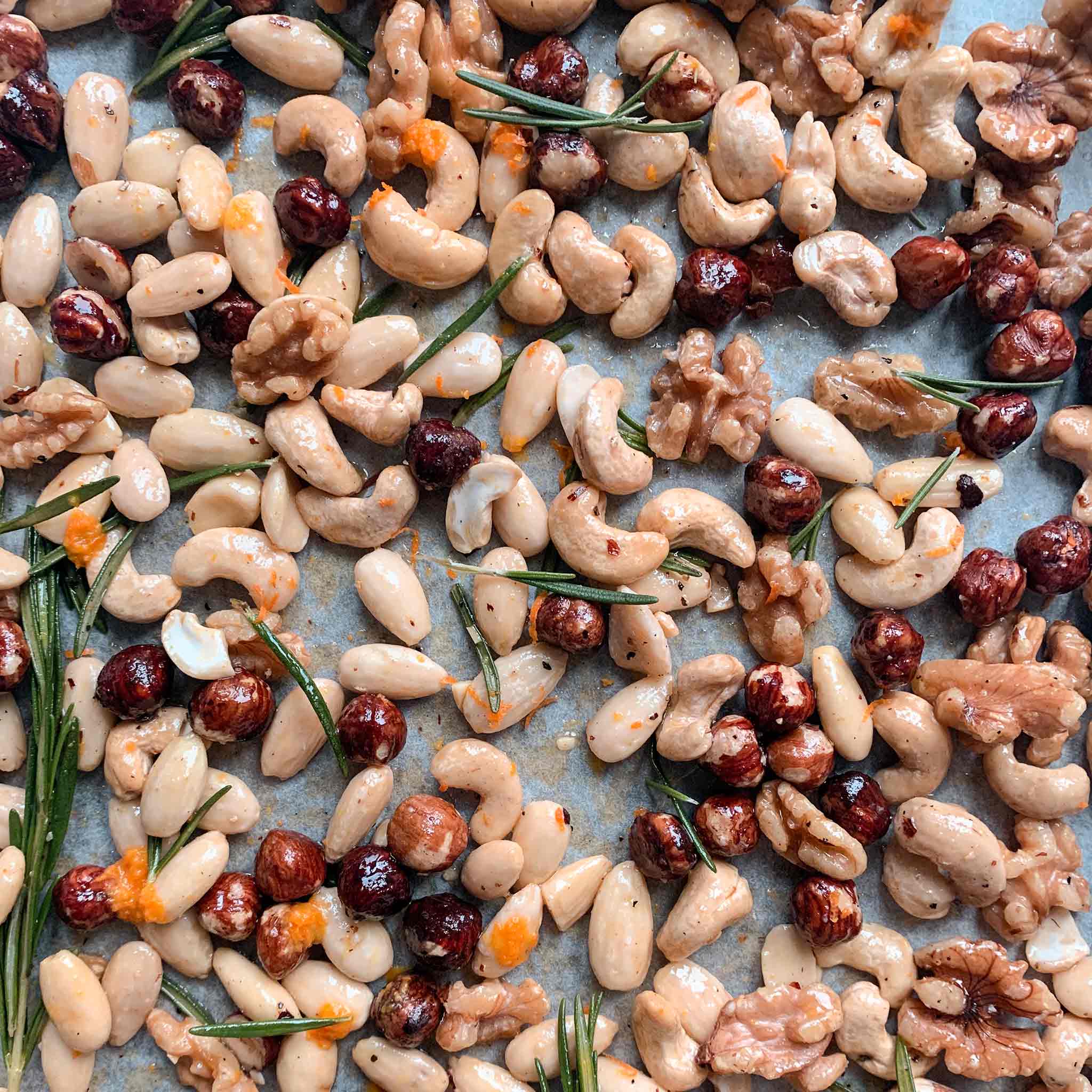 Orange and rosemary roasted nuts on a sheet pan