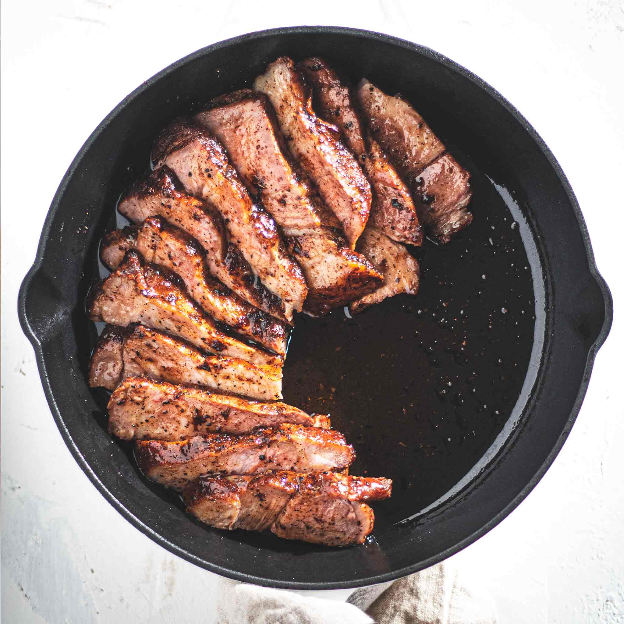 Pork shoulder steaks in a cast iron skillet