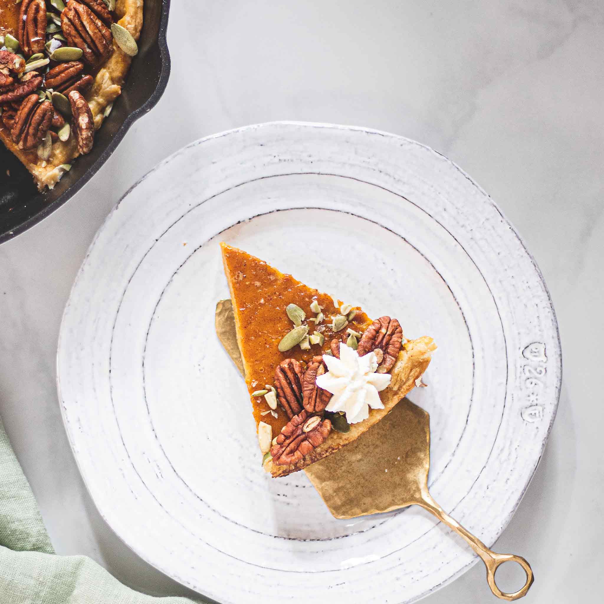 A slice of pumpkin pie on a plate