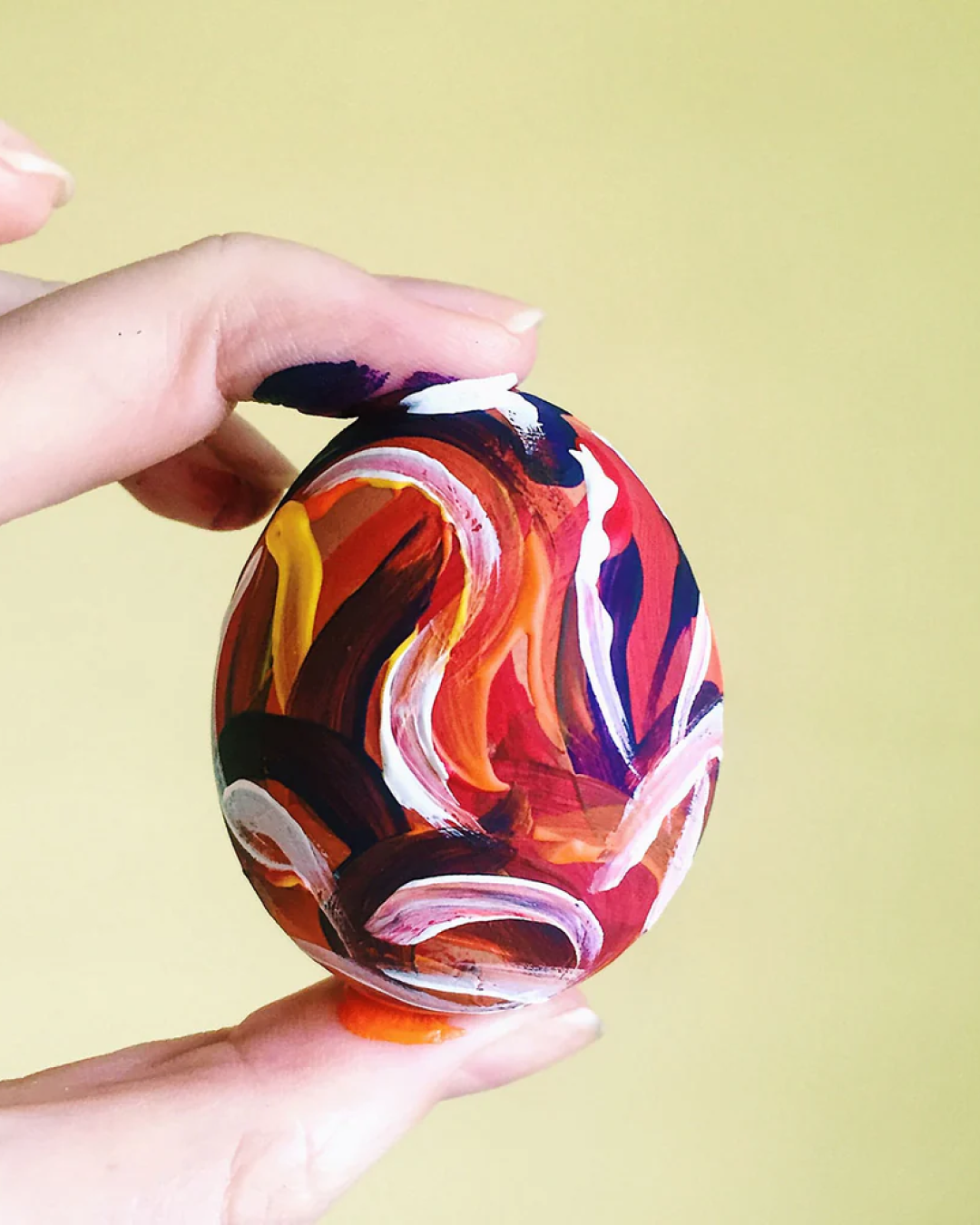 Egg decorated with acrylic paint in abstract lines