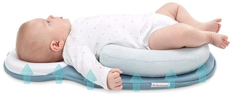 baby laying on blue infant travel bed