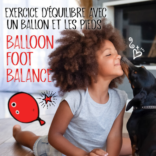 Balloon Foot Balance. A girl lays on the floor giving her dog a kiss. A cartoon balloon is on the floor in the background.