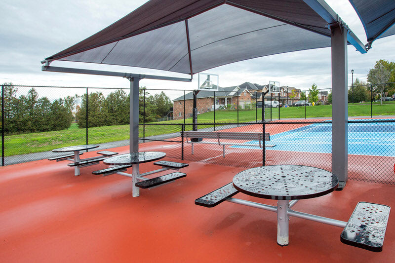 A photo of the Jumpstart Inclusive Multi Sport Court in Uxbridge, Ontario showing the shaded, accessible seating.