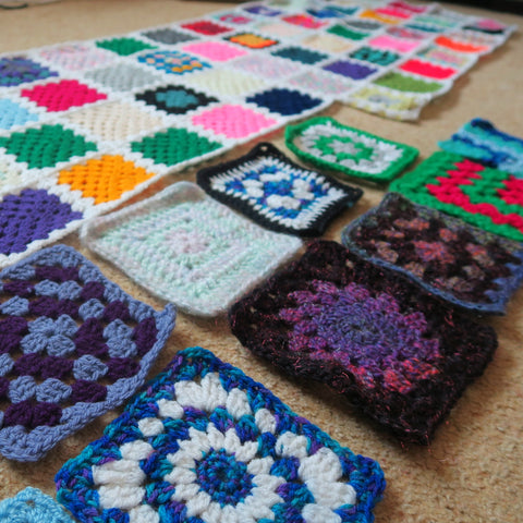 Colourful granny square blanket with random crochet squares