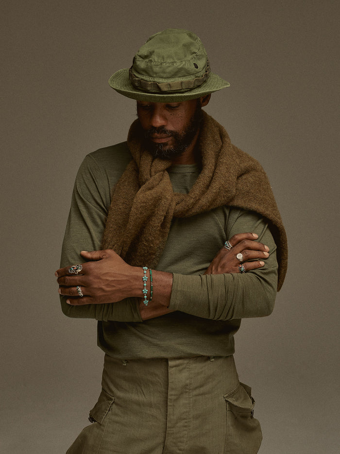 Model wearing Olive Heather Mountain-Spec Merino Eddie Bauer Base Layer Trouser 01