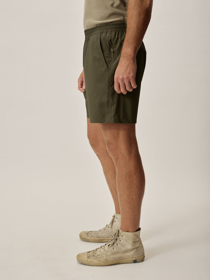 Model Wearing Trail Roam Short - Deep Olive - Side
