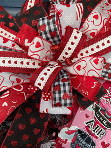 Close Up Detail of Bow with Red, White and Black Ribbons with Hearts