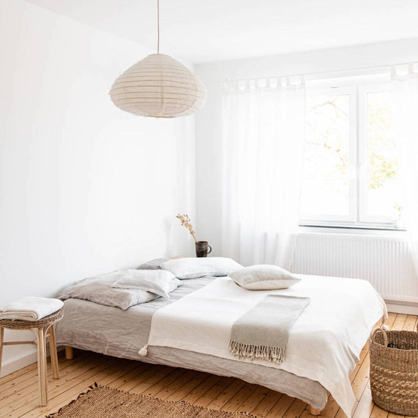 Schlafzimmer mit Leinen Lampe und gemütlichen Heimtextilien