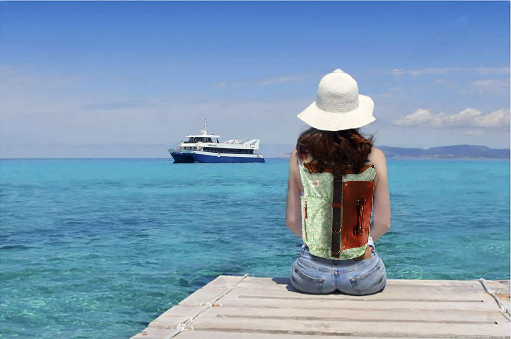 A woman with a backpack looking at the sea