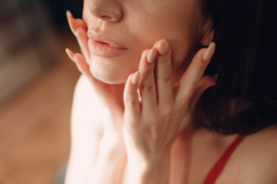 woman putting on jojoba oil