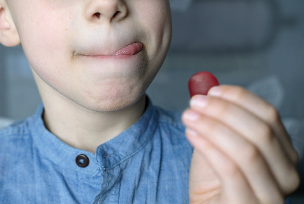 child about to eat gummy vitamin