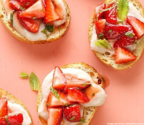 strawberry ricotta bruschetta on a table 