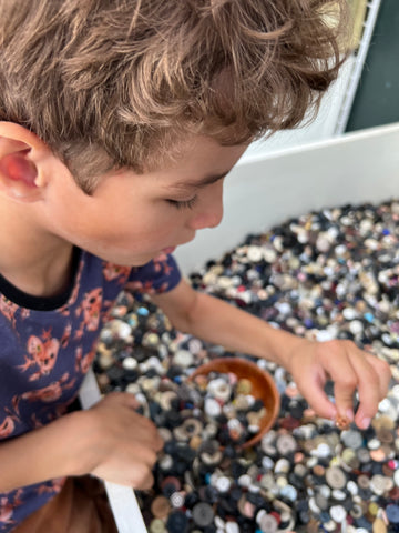 Boy sorting through buttons